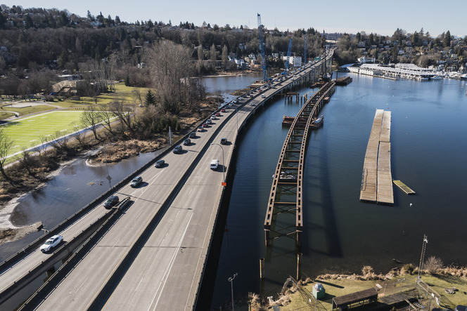 Photo shows portage bay bridges with cars and a temporary work bridge in process on the northern side