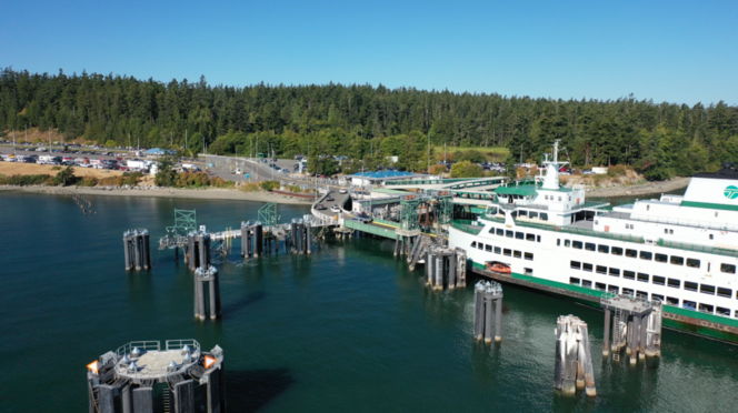 Ferry Samish docked at Anacortes terminal with vehicles departing vessel and many others in holding lanes
