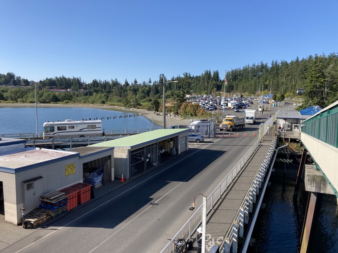 View of a Anacortes terminal from the walk-on passenger overhead loading showing vehicles boarding a ferry and in holding lanes