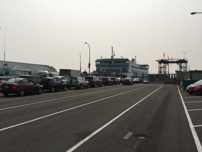 Vehicles lined up at Port Townsend terminal to board a docked ferry.