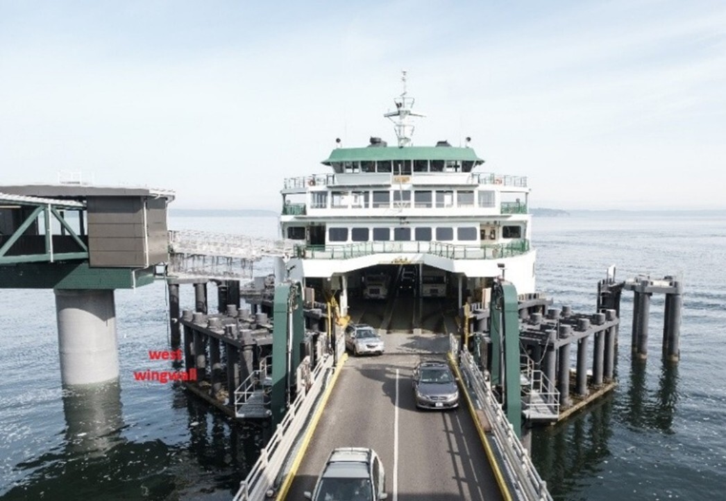 A ferry docked at a terminal with cars disembarking, and a labeled "west wingwall" nearby.