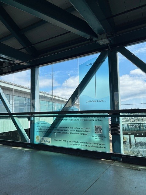 Bremerton passenger walk way has a graphic about sea level rise on the window. 