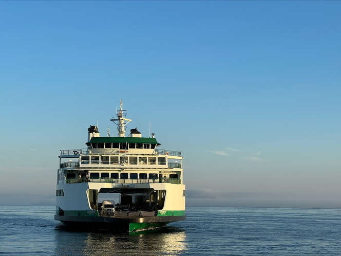 The ferry Suquamish on calm water under a clear blue sky.