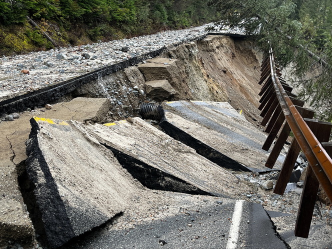 A section of State Route 20 near milepost 145 that was damaged by storms. Pavement and guardrail have slid down a hill.