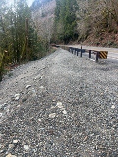 A rebuilt embankment and repaired section of State Route 20 in a rural area.