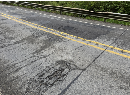 Cracked pavement on the SR 9 Lake Creek Bridge near Big Lake.