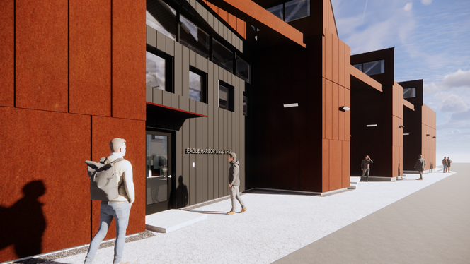 Angular modern buildings with rust-colored and gray panels and large windows along a pathway with people walking.