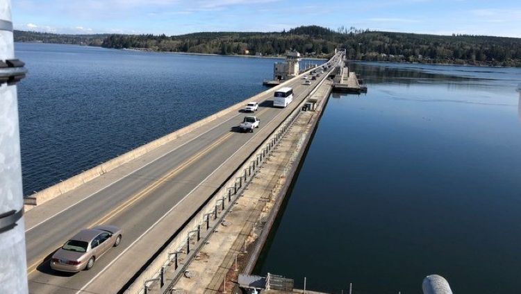 Aerial view of a two-lane bridge over a body of water with vehicles traveling in both directions.