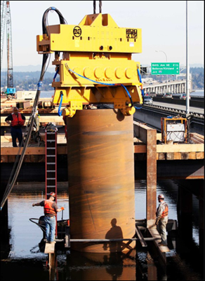 An example of crews using a vibratory hammer to vibrate the casing into the soil.