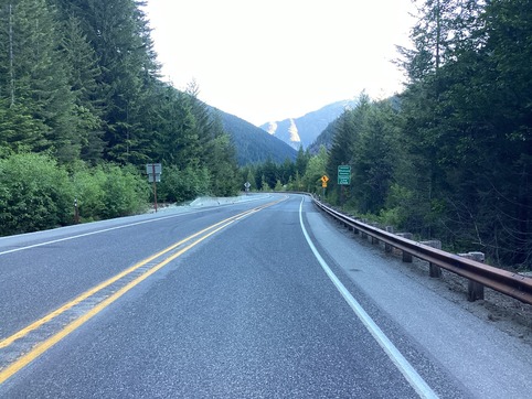 Repaired section of State Route 20/North Cascades Highway with signs saying "County Line Creek" and "Entering Whatcom County."