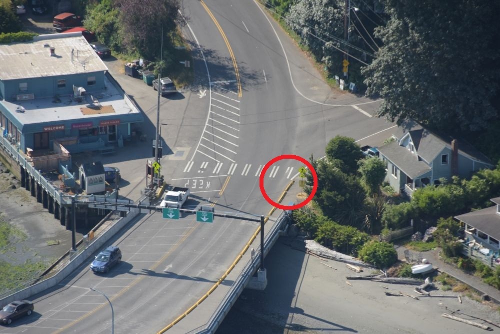 Aerial view area where the Vashon terminal dock meets land with a red circle around the westernmost lane at the crosswalk.