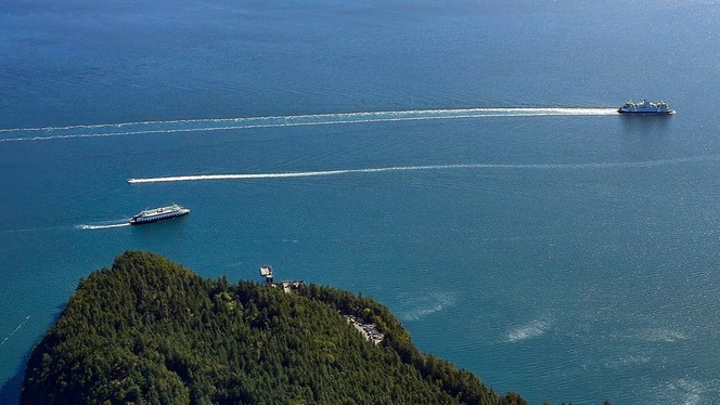 Aerial view of two ferries navigating the waters around Lopez Island terminal.