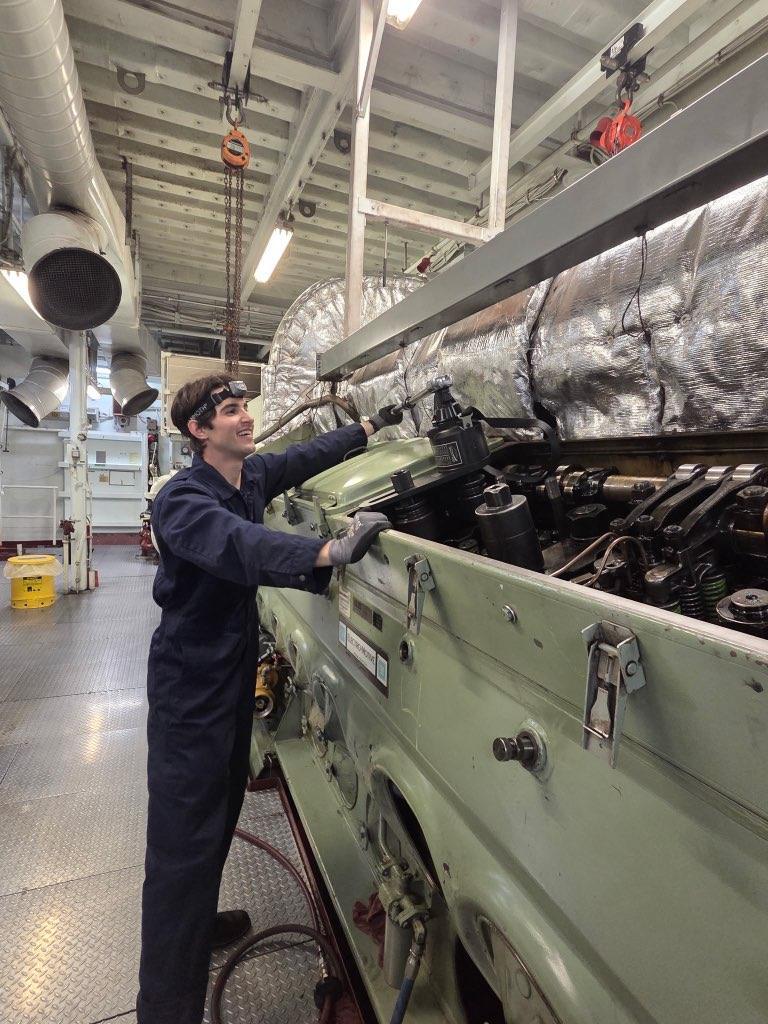 Engine room intern works on a ferry engine