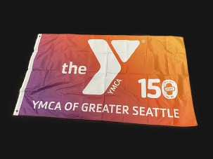 Flag of the YMCA of Greater Seattle featuring a gradient from purple to orange, the YMCA logo, and text celebrating 150 years.