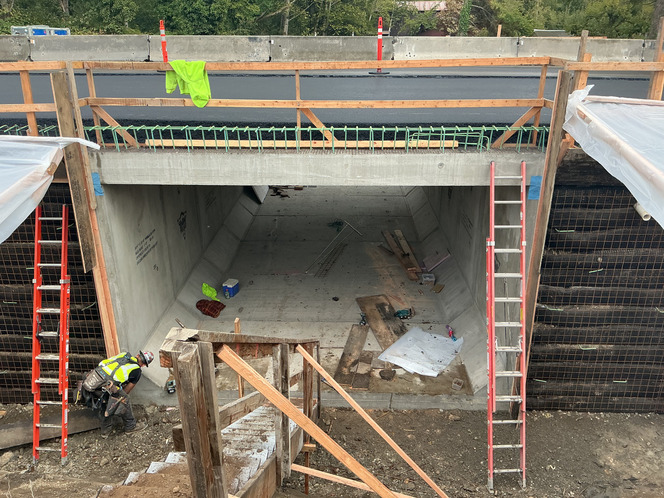 Construction work site showing work installing a new fish-passable structure under SR 9 along a tributary to Hansen Creek.