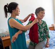 Asian woman helping her mother