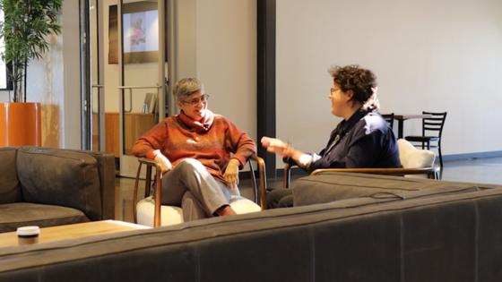 Ivanova Smith talks to Michelle Sturdevant-Case inside a coffee shop.