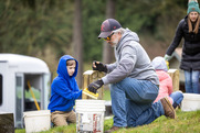 Volunteers clean headstones at Washington Soldiers Home Cemetery