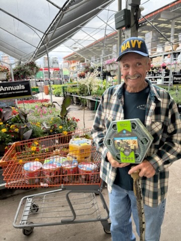 Veteran holding gardening equipment