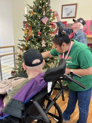 Activities staff and residents decorating a tree