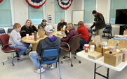 Volunteers, Residents and Clients sitting at a table