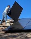 Man installing solor panels on roof - Photo by Bill Mead on Unsplash