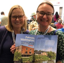 Two women holding magazine at EPA National Brownfields Conference August 2023 