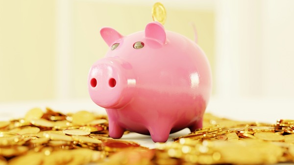 pink piggy bank on gold coins