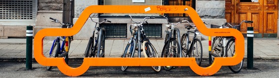 bicycles parked at car-shaped bike rack in Sweden. photo by Susan Q Yin on Unsplash