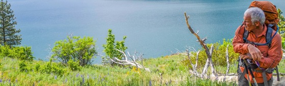 Man looking at Lake Chelan. Photo by Colton Miller on Unsplash