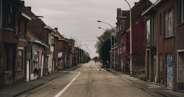 looking down a street with abandoned buildings