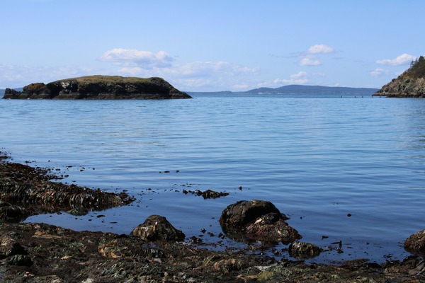 A large body of water surrounded by rocks. 