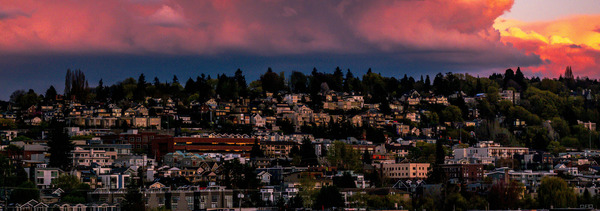 Sunset over a hill side covered in buildings