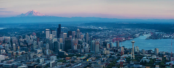 Color photo of Seattle/Puget sound skyline at dusk facing East with Mt. Rainier in the background