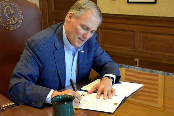 Gov. Jay Inslee signs pardons for misdemeanor marijuana possession convictions in 2019.