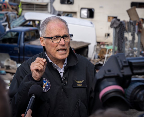 Gov. Jay Inslee tours a homeless encampment in Seattle on March 21, 2023.