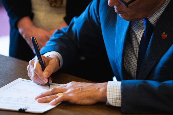 Gov. Jay Inslee signs a bill on March 30 during his first public bill action of the 2023 session.