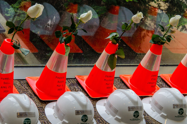 Roses adorn memorial cones each inscribed with the name of a WSDOT employee killed in a roadside accident. 