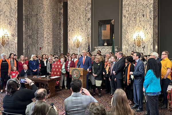 Photo of people at bill signing April 25