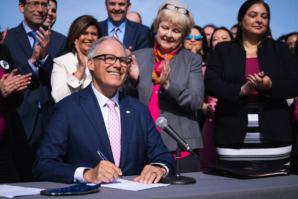 Gov. Jay Inslee smiles Thursday while signing five bills protecting women?s right of choice and patients? right to privacy in Washington state.