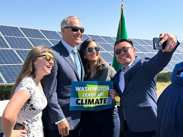 Gov. Jay Inslee poses for a selfie at a Wednesday bill signing in Richland. 