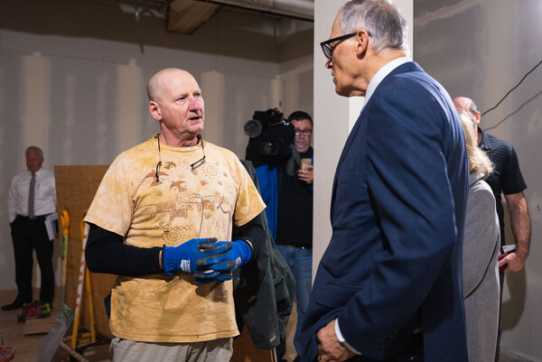 Gov. Jay Inslee chats with James, a resident of the Community House on Broadway in Longview.