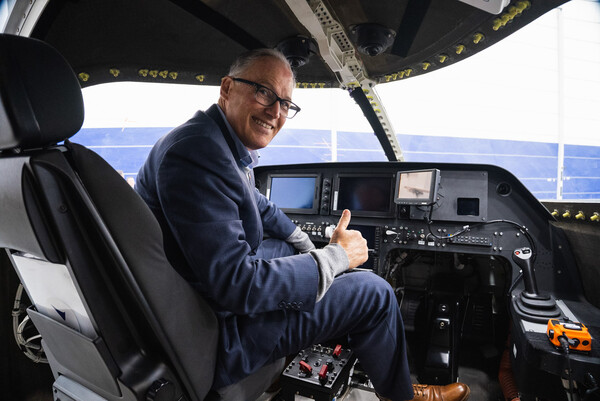 Gov. Jay Inslee gives a “thumbs-up” from the cockpit of the Eviation Alice, hangered in Moses Lake. 