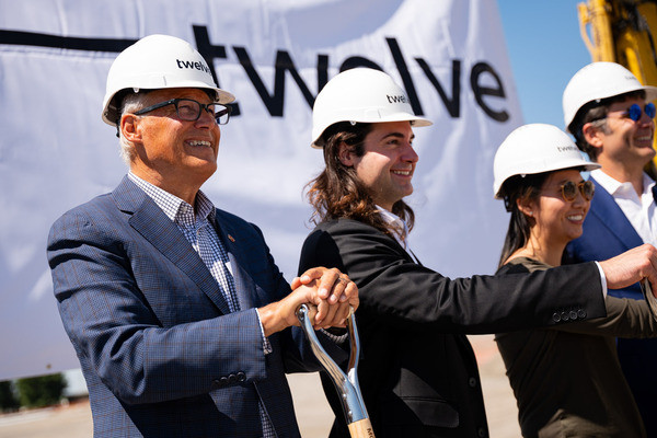 Gov. Jay Inslee holds a shovel with other executives at a groundbreaking site.