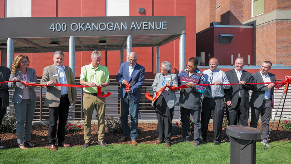 Gov. Jay Inslee and Secretary Cheryl Strange of the state Department of Corrections cut the ribbon on a Wenatchee reentry center.