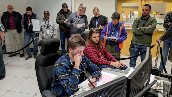 Engineers observe as molten glass is poured inside the Hanford Site.