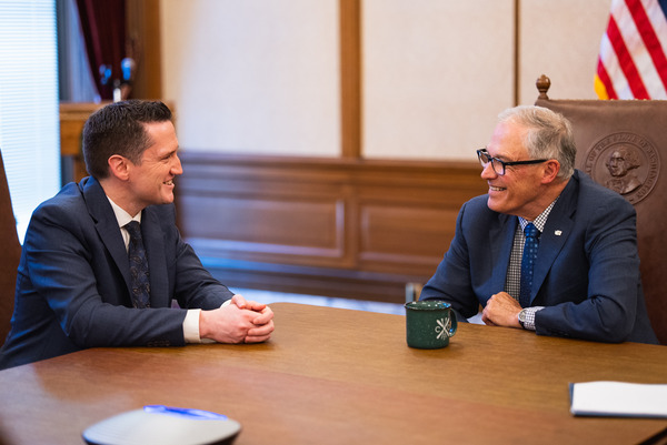 Gov. Jay Inslee chats with Quebec Environment Minister Benoit Charette in May.