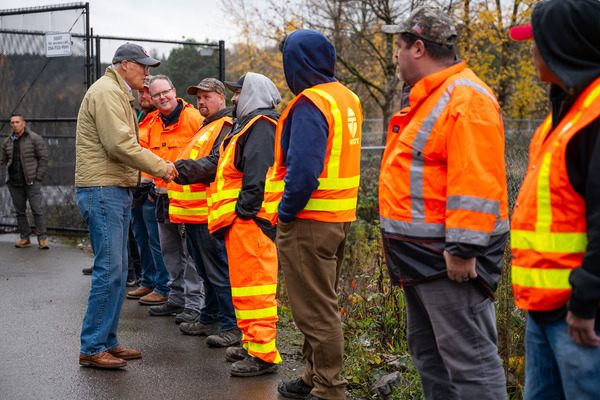 Gov. Jay Inslee shakes hands with a line of WSDOT workers.
