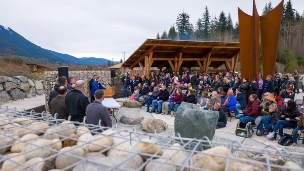 A crowd attends an event at a new memorial park remembering the Oso landslide.