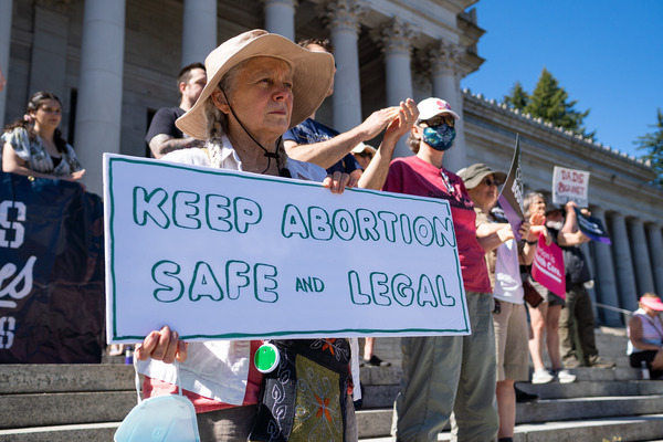 ?Keep abortion safe and legal? reads a sign held by an activist on the steps of the Washington State Capitol.